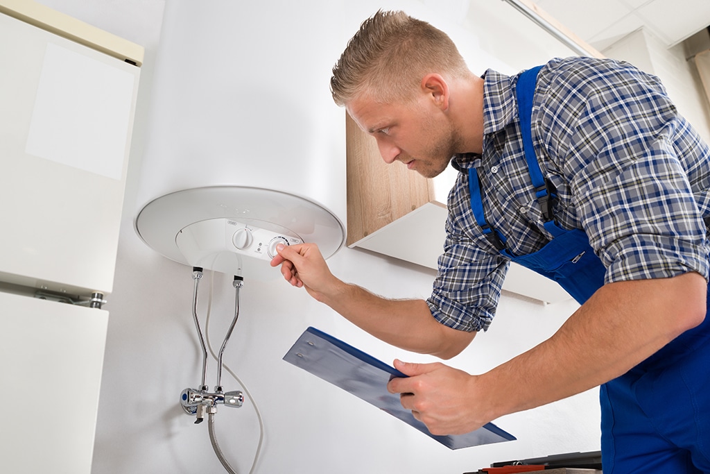 Water Heater Installation in Scarborough - ME underway as a technician connects a new residential tank