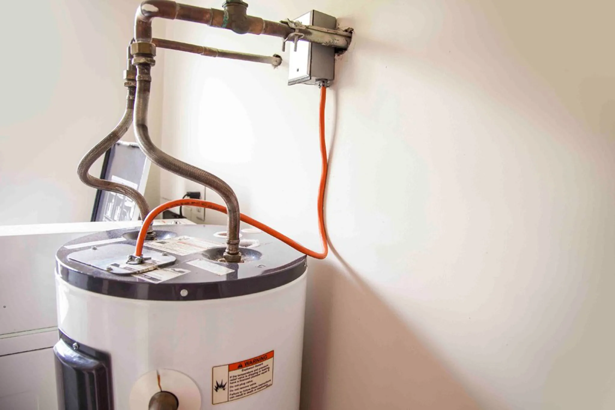 Water Heater Repair in Scarborough - ME underway as a technician checks a leaking basement tank
