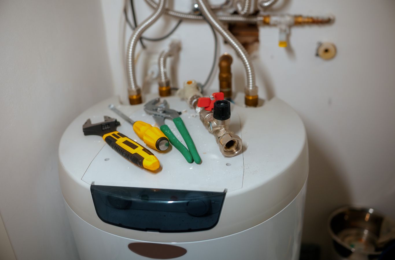 Tank fittings and tools, shown for Wanda’s Water Heaters in Windham, ME. Water Heater Installation Near Me.