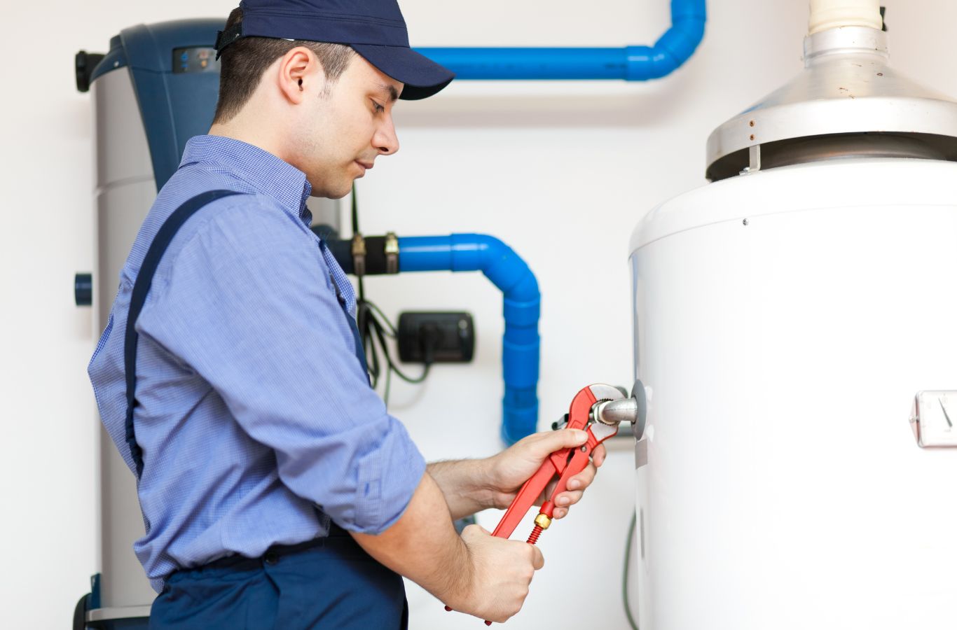 Technician using a pipe wrench, illustrating Water Heater Installation in Sanford, ME by Wanda’s Water Heaters.