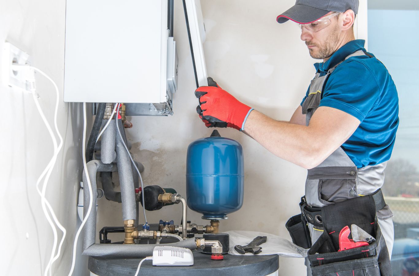 Wall unit and technician, shown for Wanda’s Water Heaters in Cumberland County, ME. Water Heater Installation Near Me.