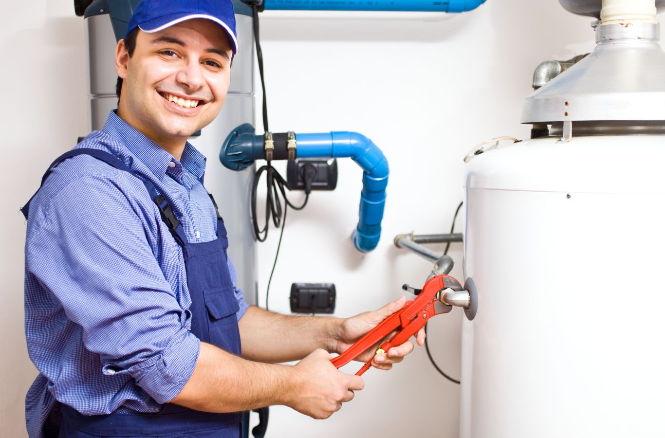 Technician with a pipe wrench, shown for Wanda’s Water Heaters in York, ME. Water Heater Installation Near Me.